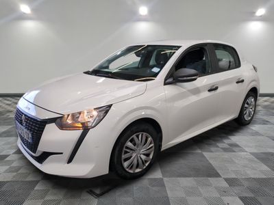 la voiture blanche est garée sur un sol en damier dans le garage