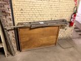 a wooden door that is open in front of a brick wall