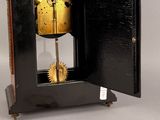 a clock that is sitting inside of a black box
