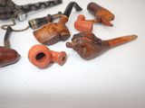 many different types of smoking pipes on the table
