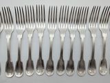 a set of six forks and a knife on a white surface