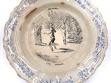 a blue and white plate with a picture of a man and a woman