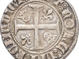 an old silver coin with a cross on it