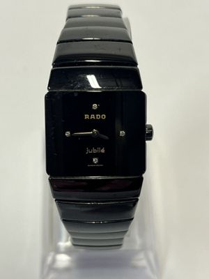 a close up of a black watch on a clear display