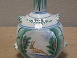 a blue and white vase sitting on a table