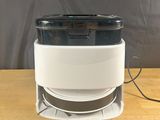 an image of a white and black air purifier on a wooden table