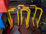 a lot of yellow and red bike racks on the floor