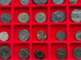 a red box filled with lots of different types of coins