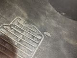 a dirty floor with a metal grate on it