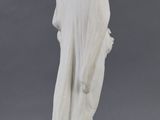white marble statue of a woman with a veil on her head