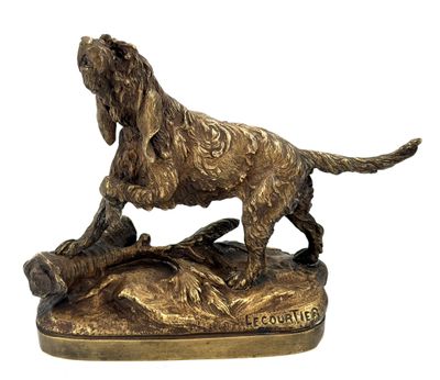 bronze statue of a dog on a rock on a white background
