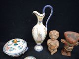 a lot of pottery items that are sitting on a black surface