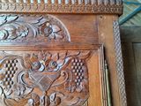 carvings on the front of a carved wooden door in a room