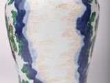 a blue and white vase sitting on a white surface