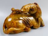 a statue of a dog laying on its back on a table