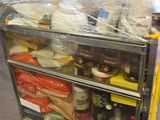 a man standing behind a refrigerator filled with food