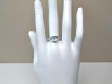 a white mannequin hand with a diamond ring on it