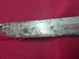 a close up of a knife on a red cloth