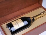 a bottle of champagne in a wooden box on a table