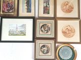 many framed pictures on the wall of this room