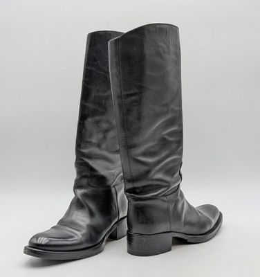 a pair of black leather boots on a white background