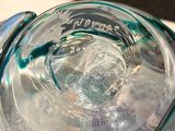a glass container with a liquid inside of it