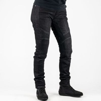 the man is wearing a black shirt and jeans and holding his hands in his pockets