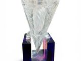 a glass perfume bottle with a diamond on top of it