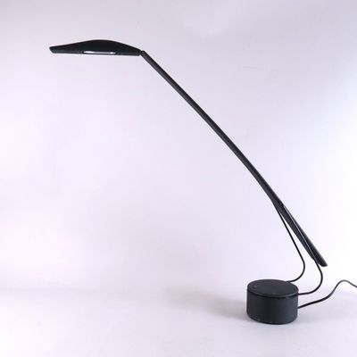 a black lamp that is sitting on a table