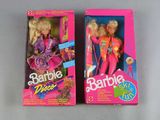 two barbie dolls are sitting in their boxes on a table