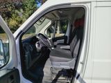a white van with the door open and the driver ' s seat down