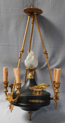 an image of a black and gold chandelier with five candles
