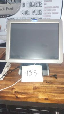 a computer monitor sitting on top of a wooden desk