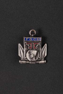 a close up of a metal badge on a black surface