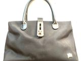a black handbag with a silver handle on a white background