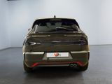 the rear end of a car in a showroom with a white wall