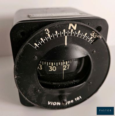 a close up of a black analog clock on a white surface