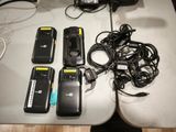 several cell phones are lined up on a table with a charger