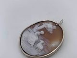 a close up of a pendant with a picture of a man and a woman