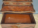 a wooden chest of drawers on a parquet floor