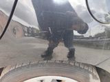 a reflection of a man in the rear of a car