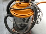 a machine that is sitting on the floor with a hose