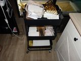 a black cart with food on it in a kitchen