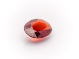 a close up view of a red diamond on a white surface
