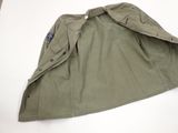 an image of a military jacket laying on a white surface