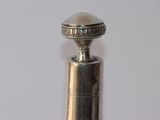 a close up of a silver object on a white surface