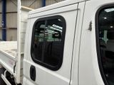 a white truck with a flat bed parked in a warehouse