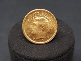 a gold coin sitting on top of a black box
