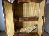 a wooden cabinet that has a yellow striped cloth on it