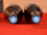two bottles of wine that are sitting on a table